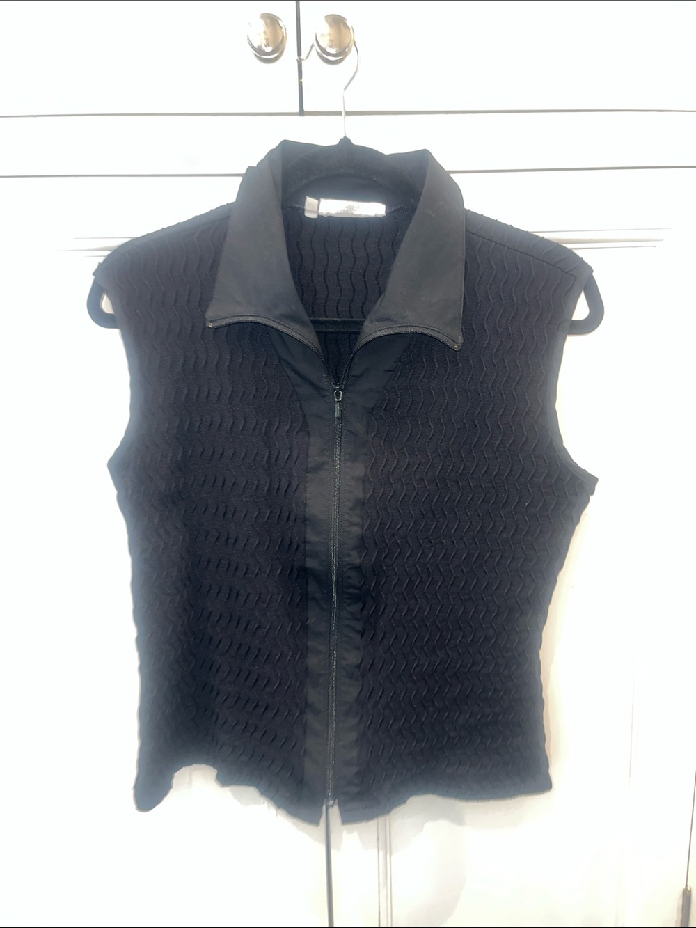 Black Textured Sleeveless Zip Front top
RAYURE Paris